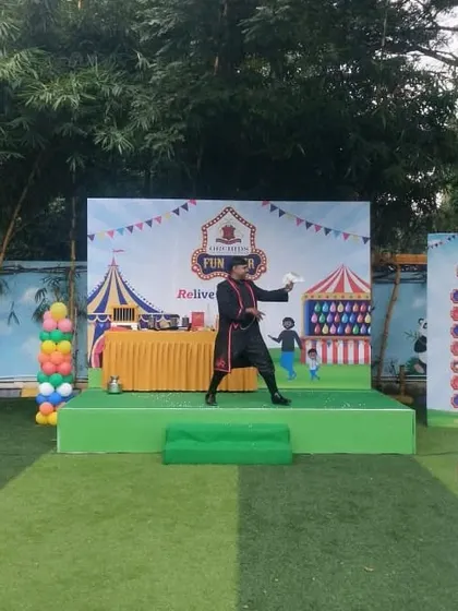 The magical appearance of a dove, a classic illusion that never fails to amaze the audience, especially in the bright light of an outdoor family event.