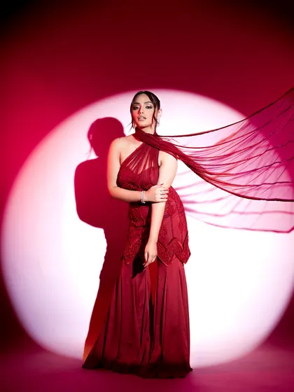 This flowing red gown makes a powerful statement with its asymmetrical neckline and dramatic silhouette. I styled this look for maximum impact, perfect for a cocktail evening or a red-carpet-themed wedding event.
