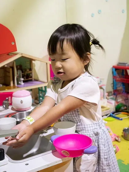 Learning and playing in our mini-kitchen. It's a great spot for toddlers to practice real-life skills in a fun, safe setting.