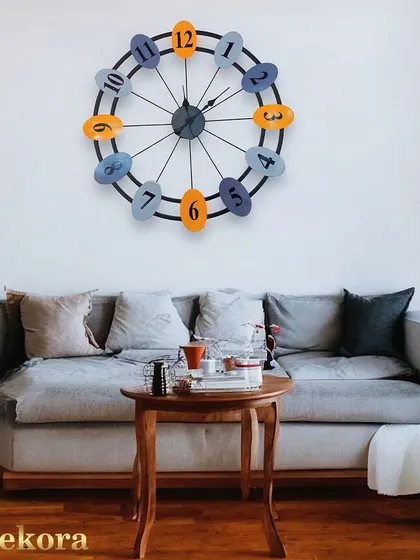 A playful and colorful metal numeric wall clock, with alternating blue and orange numbers that add a fun pop of color to a family room or kitchen.