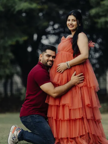 He's already so in love with their little one. A heartwarming shot from a maternity shoot featuring our popular peach rental gown.