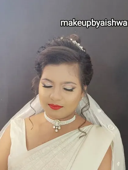 A full view of the Christian bridal makeup and hair. The updo is adorned with a delicate tiara, perfectly complementing the veil and the overall graceful look.