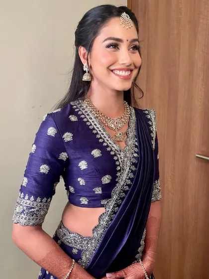 A joyful smile that perfectly completes this elegant reception look.