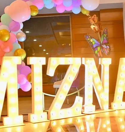 Large marquee letters spelling out the birthday girl's name, "MIZNA". This is a key feature of our personalized party decoration services.