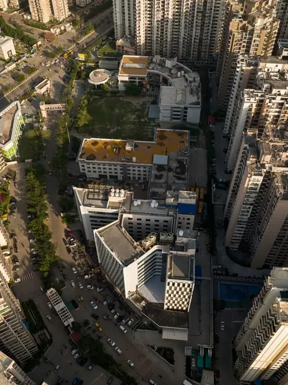 This aerial view shows Sarvodaya Hospital integrated within its dense urban fabric. Our adaptive reuse strategy allowed for the rapid expansion of critical healthcare access in the region by utilizing an existing structure, minimizing construction time and resource use.
