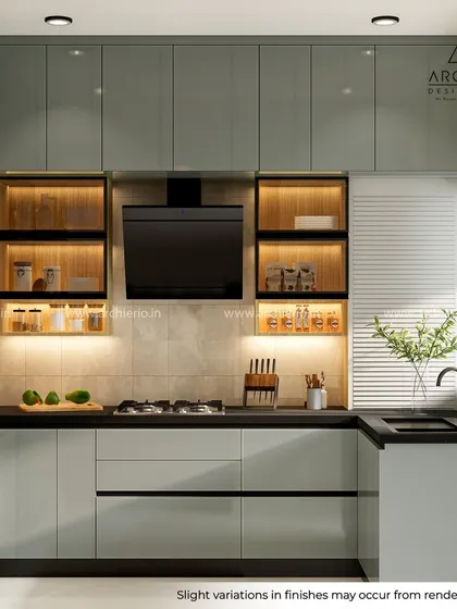 This U-shaped modular kitchen showcases a balanced design with sage green cabinets, open-lit shelving for spices, and a sleek black chimney, creating a modern and efficient cooking area.