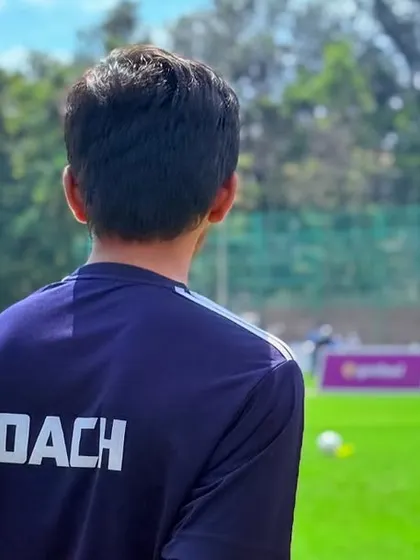 A coach watches over his players during a KSFA Youth League U11 game. We are there to guide them every step of the way.