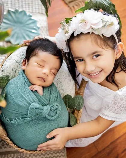 Welcoming a new baby is a special time for the whole family. The pride and love in this big sister's smile as she holds her newborn sibling is just the sweetest. Sibling and newborn photography is a beautiful way to document the start of their lifelong bond.