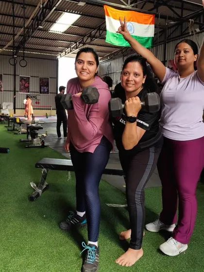 The strong women of Adapt Fitness Club. Here, we focus on building functional strength with exercises like dumbbell presses, empowering our members to feel capable and confident.