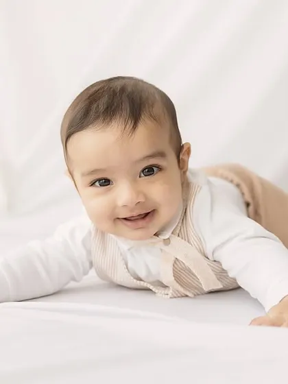 A sweet and curious crawler. This baby's engaging expression and the simple, clean setup create a timeless portrait.