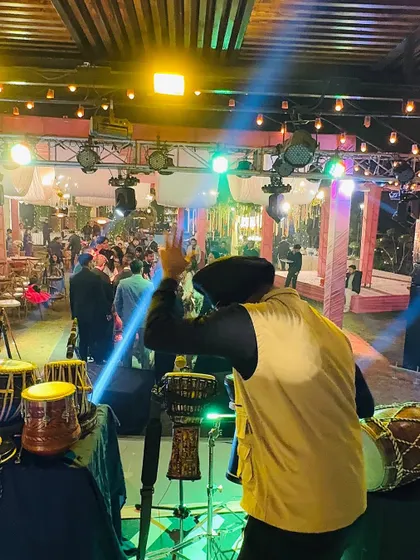 Waving to the crowd during a live wedding show. Connecting with the audience is a key part of every performance.