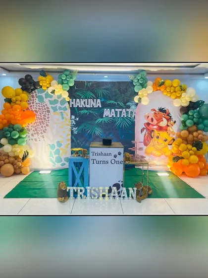 For Trishaan's first birthday, I designed a "Hakuna Matata" theme from The Lion King. The setup includes a jungle backdrop, character cutouts of Timon and Pumbaa, and balloon arches in savanna-inspired colors for a worry-free celebration.