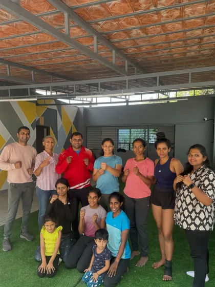 A proud group photo after a successful women's self-defence workshop. The smiles and strong stances say it all.