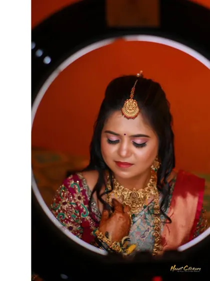 A beautiful bridal portrait framed within a ring light. The soft, even lighting perfectly highlights her intricate jewelry and makeup.