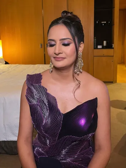 Slaying for her 25th anniversary party! This look features a dramatic purple smokey eye and a flawless base to match her stunning Amit Aggarwal gown.