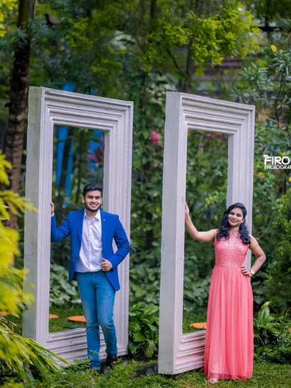 A fun and creative shot with the couple framed by giant picture frames. This prop adds a playful and artistic element to the pre-wedding shoot.