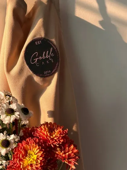 My trusty Gobble Cake apron. Flour, flowers, and a dash of sweetness have been my recipe for a perfect day since 2014.