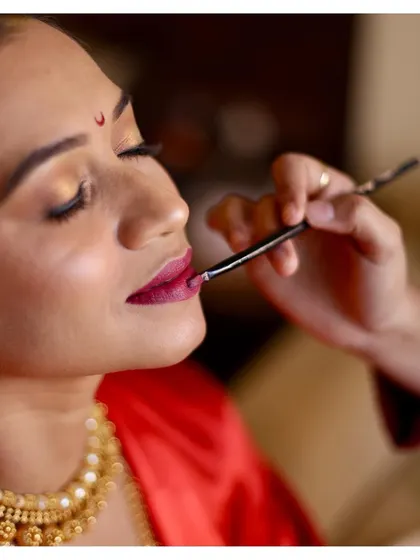 This is a close-up of a precise lip application. Learning this technique helps prevent feathering and ensures your lipstick wears evenly throughout the day, a skill you can use forever.