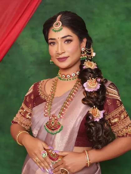 This angle showcases the complete look, from the intricate jewellery and messy braid to the flawless makeup. It's a perfect blend of traditional elements with a touch of modern hairstyling.