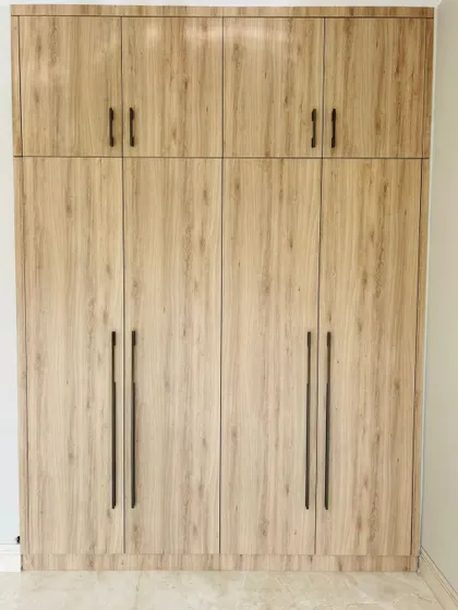 This floor-to-ceiling wardrobe is finished in a premium laminate with a realistic wood grain texture. It offers the timeless look of veneer with enhanced durability and ease of maintenance.