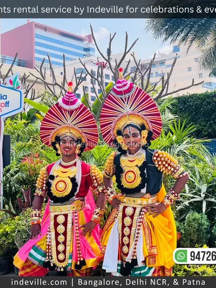 Performers in traditional attire pose amidst the lush greenery my team arranged for an event. The vibrant plants provide a beautiful natural backdrop for photos and enhance the festive atmosphere.