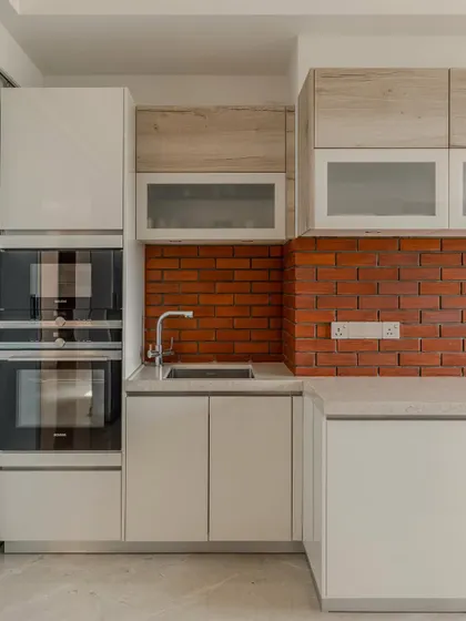 A look at the integrated appliance tower in Hina Gandhi's Ahmedabad kitchen. The stacked Siemens ovens are framed by high-gloss lacquer cabinetry, demonstrating how we blend high-performance technology into our designs.