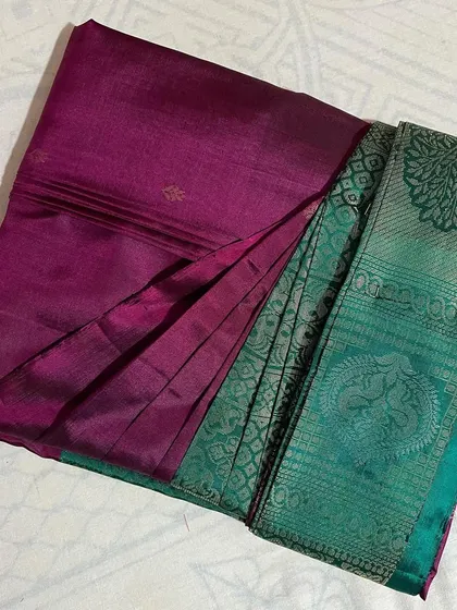 A lovely magenta and teal green saree, pleated and ready. My service helps you manage your entire saree collection with ease.