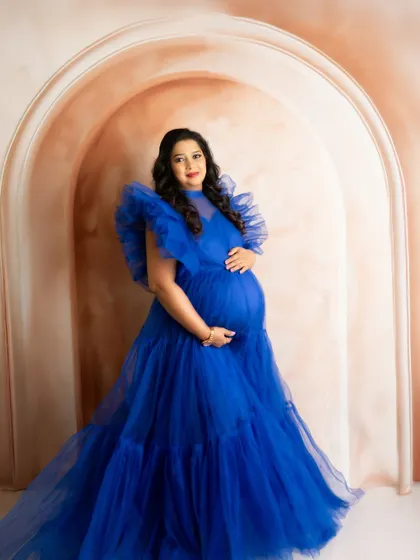 A stunning portrait in a royal blue ruffled gown. The rich color and voluminous dress create a powerful and unforgettable image.