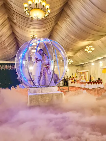 A still shot of the Crystal Ball entry, showing how the couple is encased in the illuminated sphere amidst a sea of low fog. This rental is perfect for indoor banquet halls and creates a magical atmosphere.