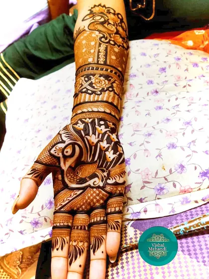 This design features a prominent peacock, a classic motif in Indian mehandi. The negative space makes the peacock stand out beautifully.