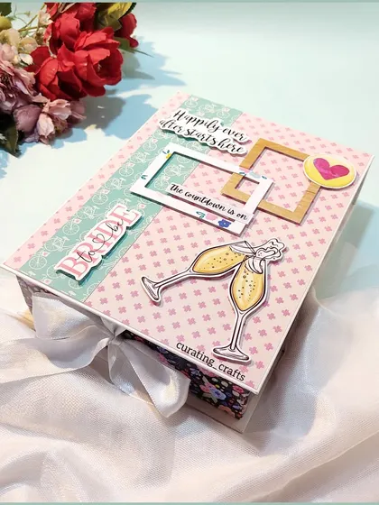 A special scrapbook for a bride-to-be. The cover celebrates her journey to "happily ever after" with champagne glass cutouts and a soft, bridal color palette.