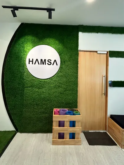 Our branding at the Hamsa Learning Centre. The green moss wall and clean logo reflect our connection to nature and our mission of harmony.