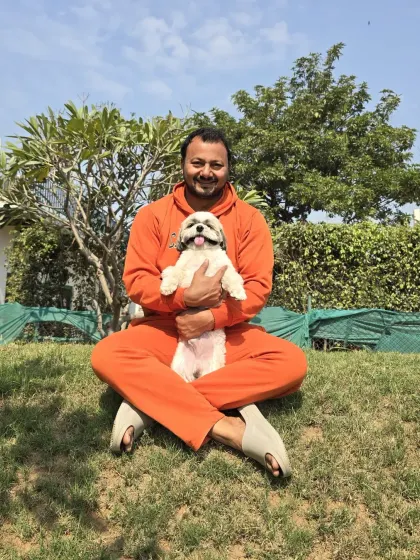 This is the most important part of my job: building trust. When you leave your bachha with me, my first priority is to make them feel safe and loved. A quiet moment on the grass with this little Shih Tzu is just as important as any training session.