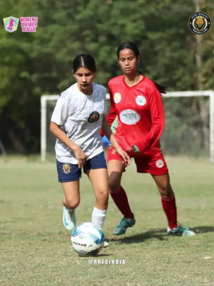 A moment of intense competition as our player holds off a defender to maintain control of the ball.
