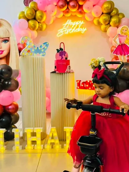 Come on Barbie, let's go party. This Barbie-themed setup for Niharika is all about pink and glam, with large character cutouts, a pink and gold balloon arch, and themed props.