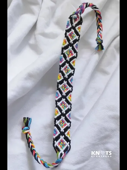 Another look at the rainbow diamond bracelet, showcasing its full length and colorful braided ends.