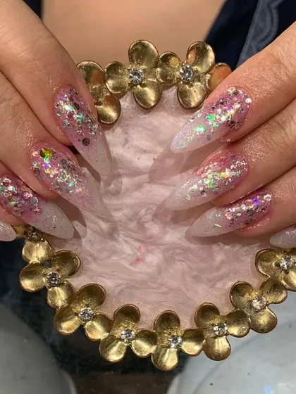 Full-on glamour with these stiletto nails covered in chunky pink and silver holographic glitter.