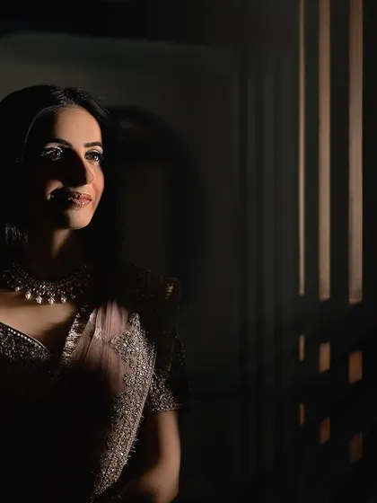 A beautiful play of light and shadow in this artistic bridal portrait. The light catching her face highlights her gentle smile.
