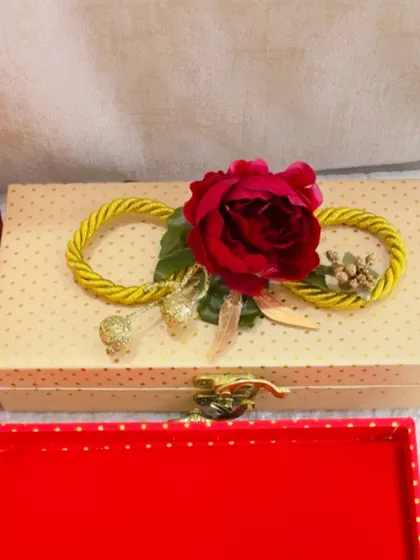A beautifully decorated gift box with a red rose on top, showing the elegant and customizable packaging options I provide.