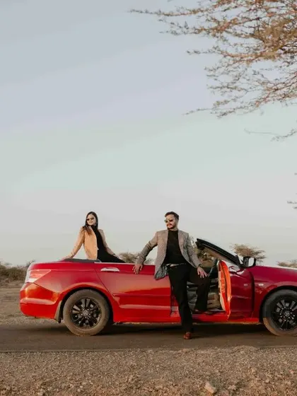 Another adventurous pose with the red convertible, capturing the feeling of a romantic getaway.