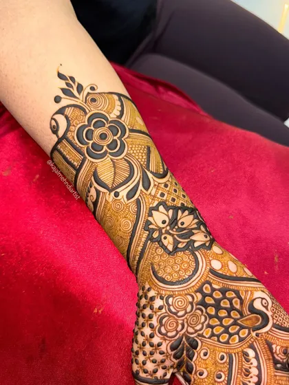 A close up of the forearm portion of an engagement henna, featuring a bold, modern flower.
