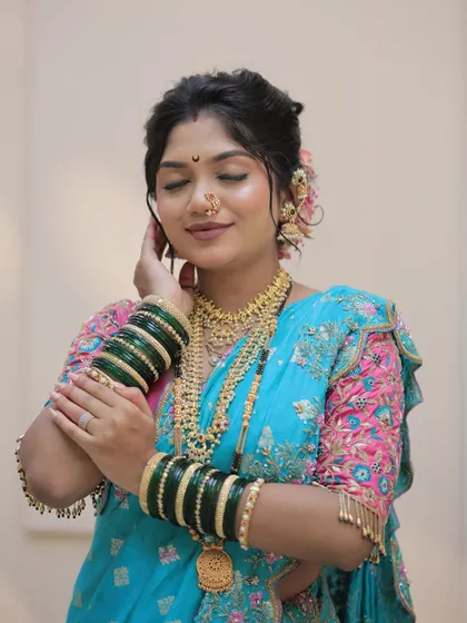 The complete Gudi Padwa look, showcasing the beautiful blue and pink saree, green bangles, and a soft, elegant hairstyle.