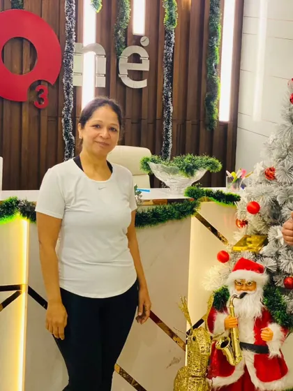 A trainer gives a thumbs-up alongside a member, celebrating her commitment to fitness during the holidays.
