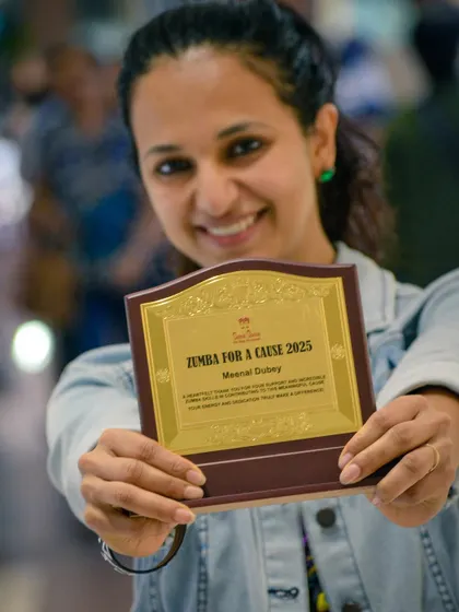 Holding an award for my participation in the 'Zumba for a Cause' 2025 event. I am committed to using my skills to make a positive impact in the community.