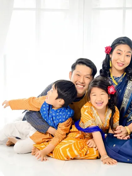 A candid and joyful family moment. The bright, natural light from the window creates a happy and authentic feel for this family portrait.
