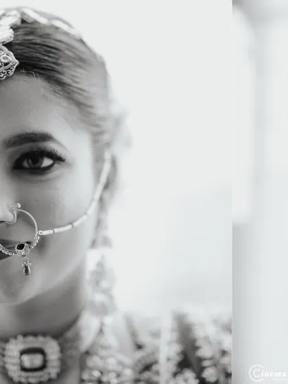 An artistic half-face portrait in black and white, creating a sense of mystery and highlighting the bride's beautiful features.
