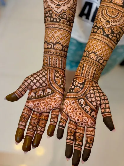 Nikita's wedding mehendi, featuring delicate elephant motifs and Swastika symbols for good fortune.