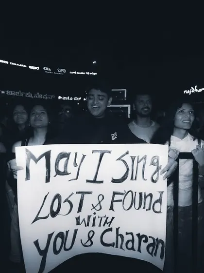 A dedicated fan holds up a sign, hoping for a special moment with the artist. I strive to create an atmosphere where fans feel connected and part of the show.