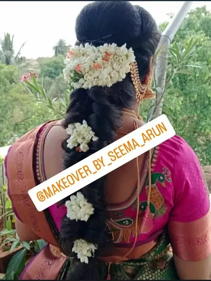 A beautiful traditional braid decorated with fresh flowers, perfect for a baby shower or any festive occasion celebrated in a saree.