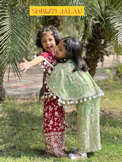Capturing the pure joy of sisterhood is what I love most. I designed these coordinating sets in rich maroon and soft green with playful pom-pom details, ensuring they are as comfortable as they are cute for a day of fun.